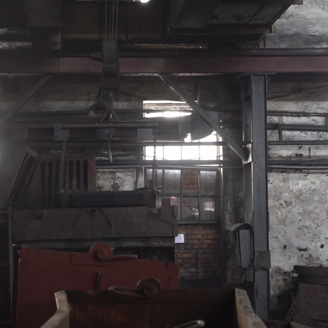 Factory overhead crane inside factory building. Factory room structure made from iron and steel. Old industrial grunge wall with metal structures