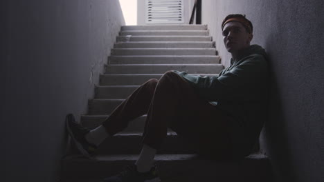 young man sitting on stairs