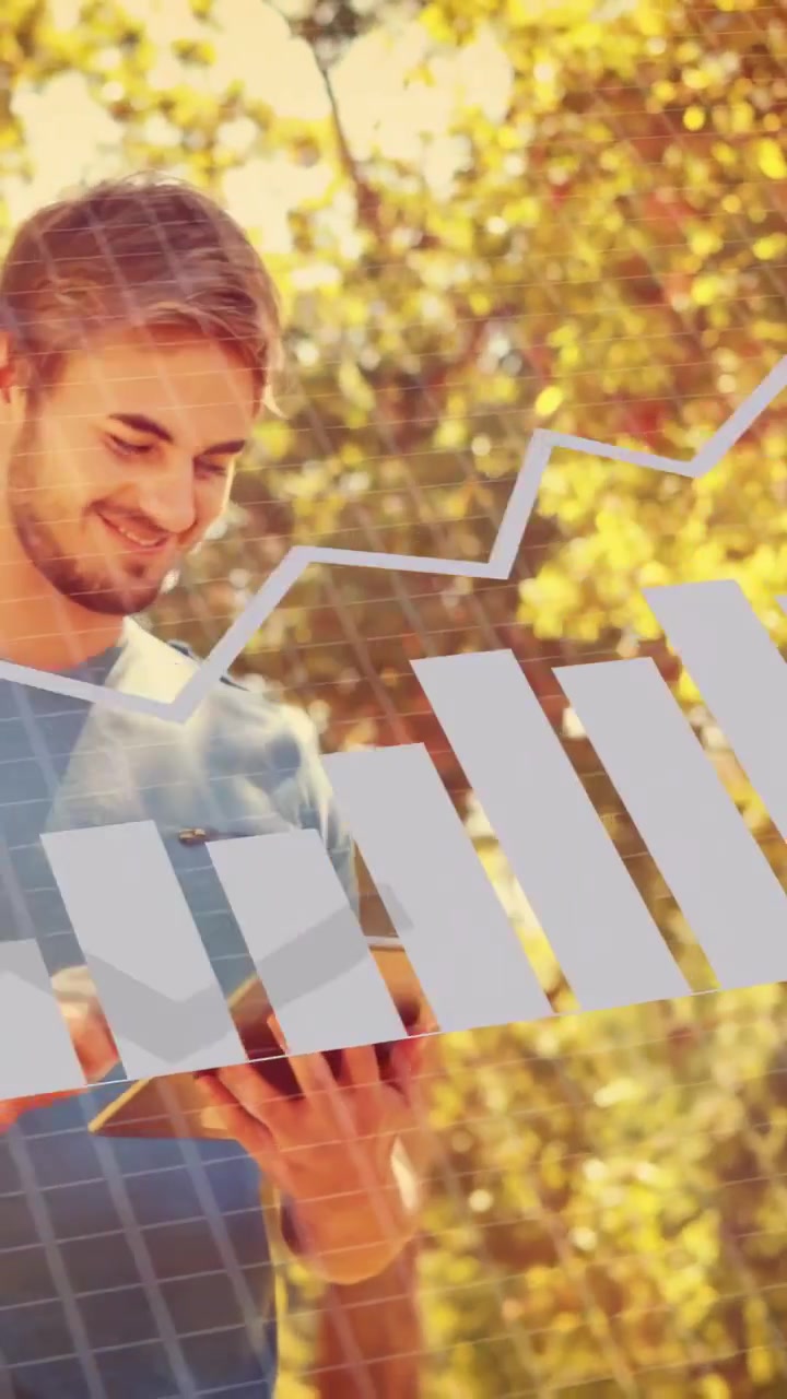 Vertical video: Man tapping tablet in park, analyzing tech overlay with pie bar line binary charts