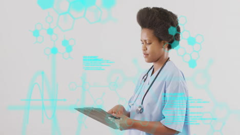 female medical professional tapping tablet in studio, showcasing hexagonal medical data visuals