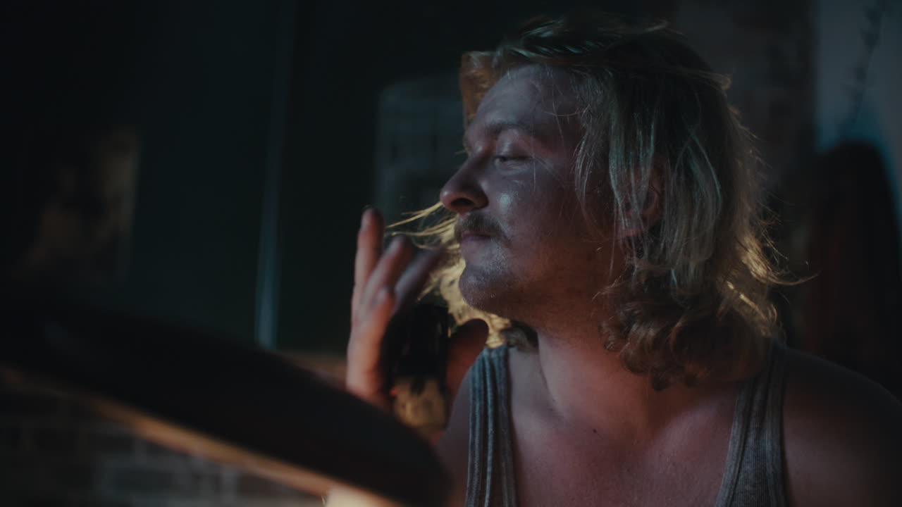 Man looking at mobile phone in the dark room