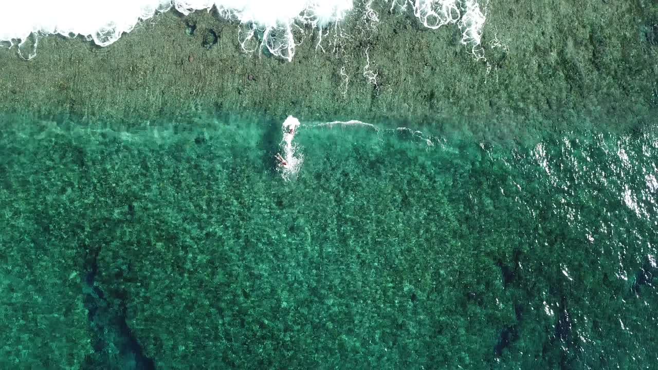 Bird's Eye Shot Over Two Surfers Catching For An Unbroken Wave on Siargao Island