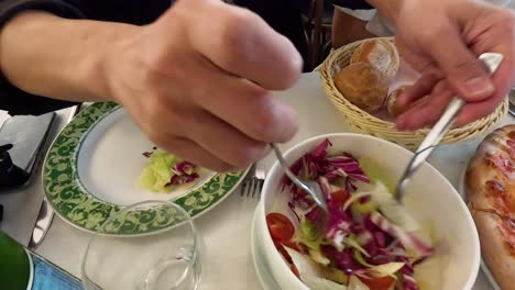 person preparing salad at a restaurant in milan