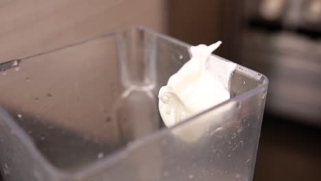 pouring yogurt into a blender