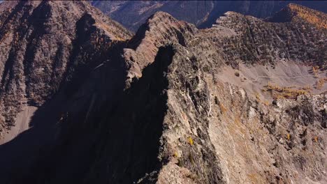 Flying-above-the-ridgeline-high-in-the-alpine-of-Purcell-mountains,-autumn