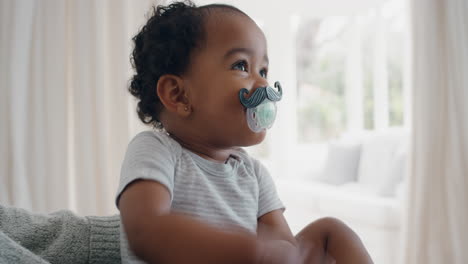 funny baby wearing moustache pacifier happy toddler sucking on dummy having fun cute infant enjoying silly humor at home 4k