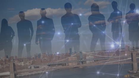 animation of silhouette of businesspeople and network of connections against view of cityscape