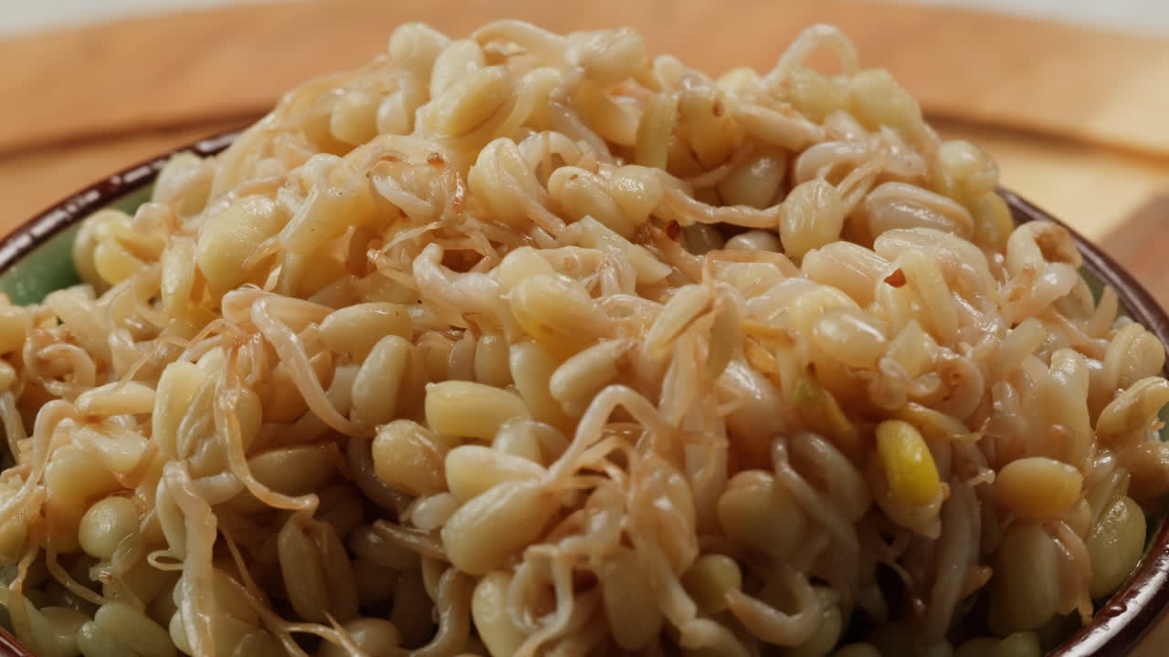 Salted soybean fermented in jar, chinese soy production, marinated food, germinated soy close up in cafe restaurant.