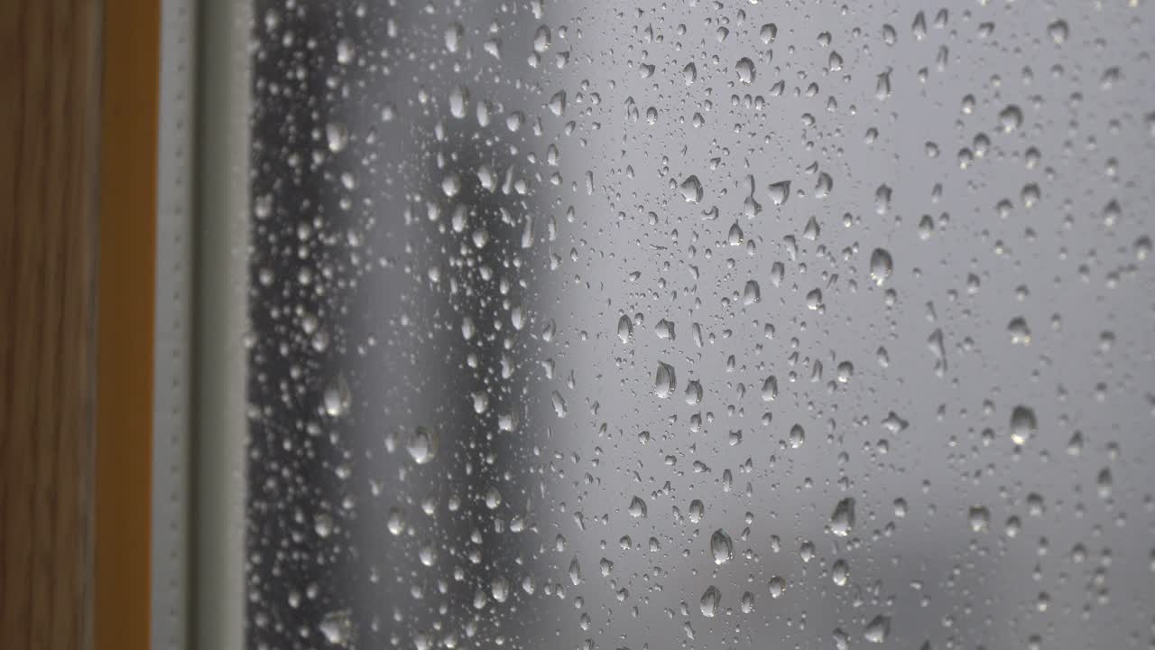Raindrops Dripping On The Blurry Window Exterior - close up