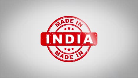 made in india signed stamping text wooden stamp animation. red ink on clean white paper surface background with green matte background included.