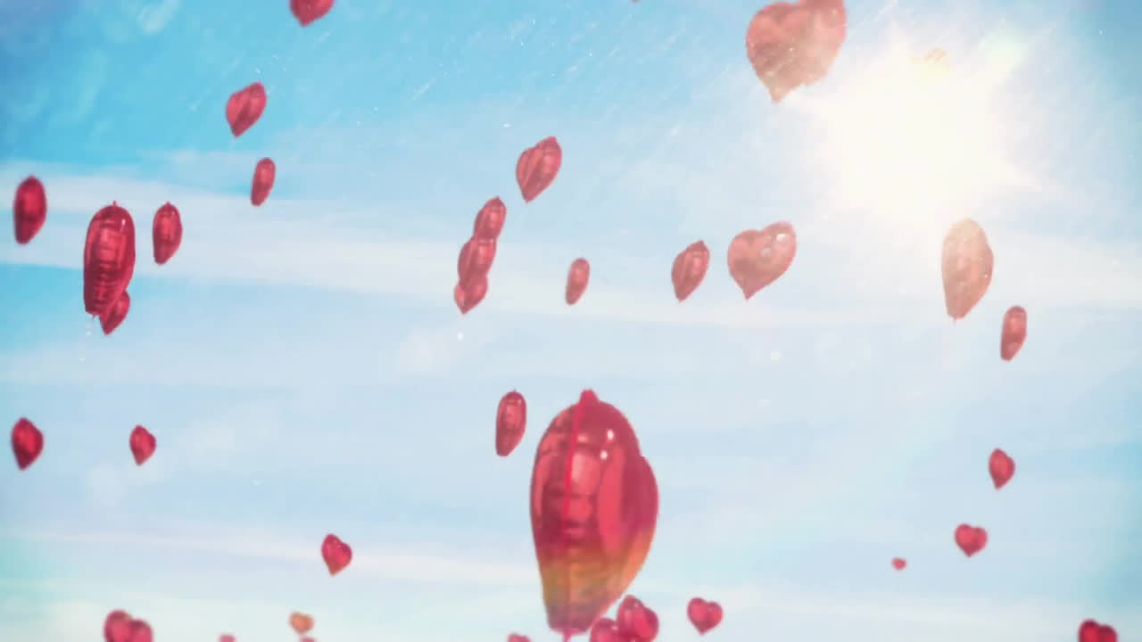 Animation of red heart balloons rising in sunny blue sky