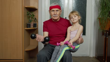 grandfather and granddaughter workout together at home