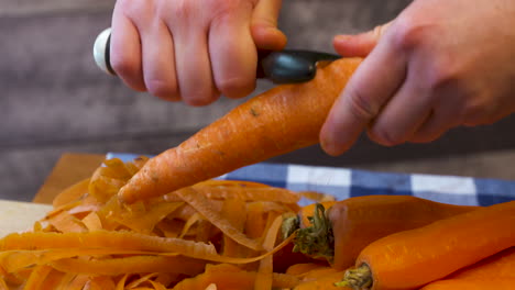 peeling fresh, ripe, whole carrots