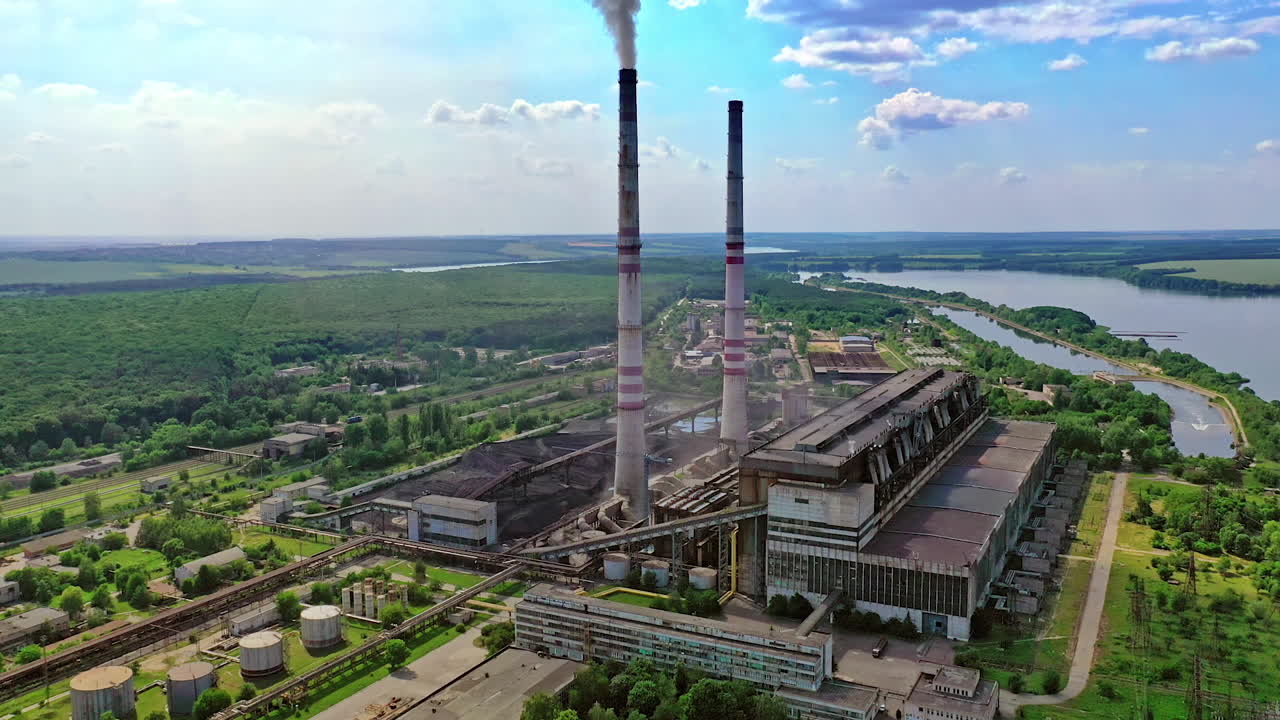 Factory air pollution. Plant emits smoke and smog from the pipes