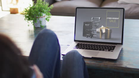 Woman-at-table-using-laptop,-online-shopping-on-cyber-monday-sale-day,-slow-motion