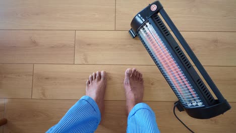 barefoot on wooden floor with a heater