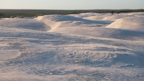 sand blowing across sandunes in windy conditions