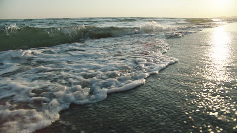 waves on the beach at sunset