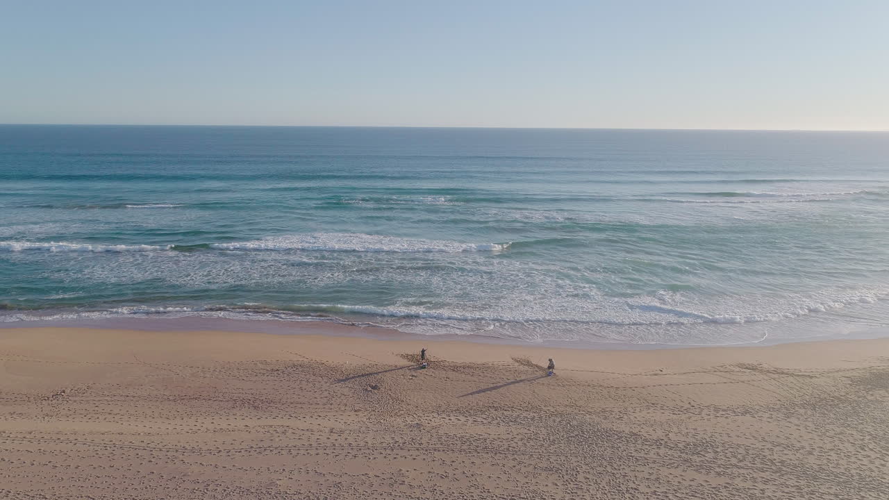 Aerial shot of fishermen on a beach in South Australia