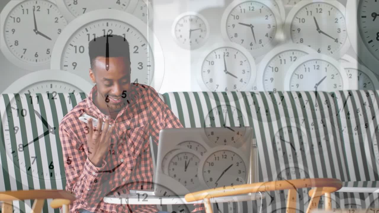 Man tapping smartphone and activating animated clock cascade while referencing PC for business call