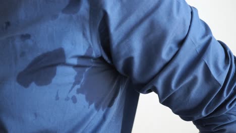 close-up of a sweat stain on a blue shirt