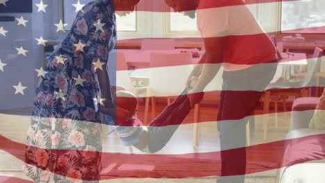 mixed race family playing together with us flag waving foreground