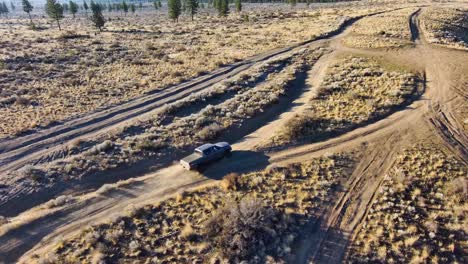 rotating around a truck from above as it drives remote off-road trails, 4k 60fps