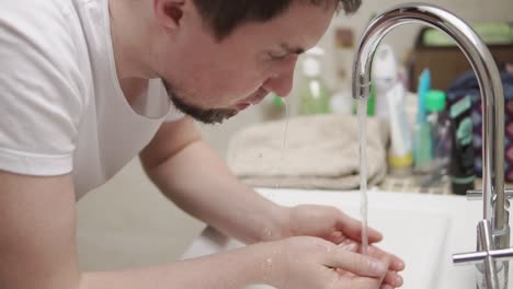 man washing his face