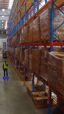 warehouse worker on hoverboard at warehouse