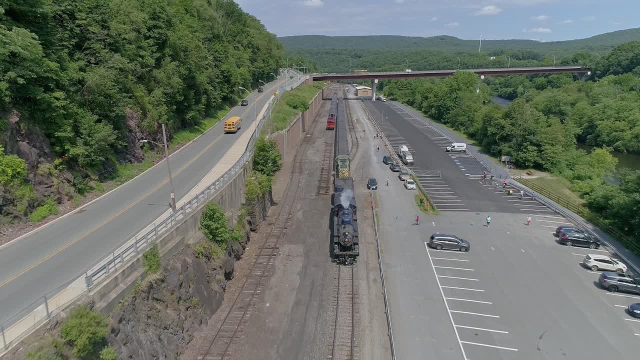 Blue Steam Passenger Train and Diesel Exploring the Scenic Railway and Parking Area Near the Mountains