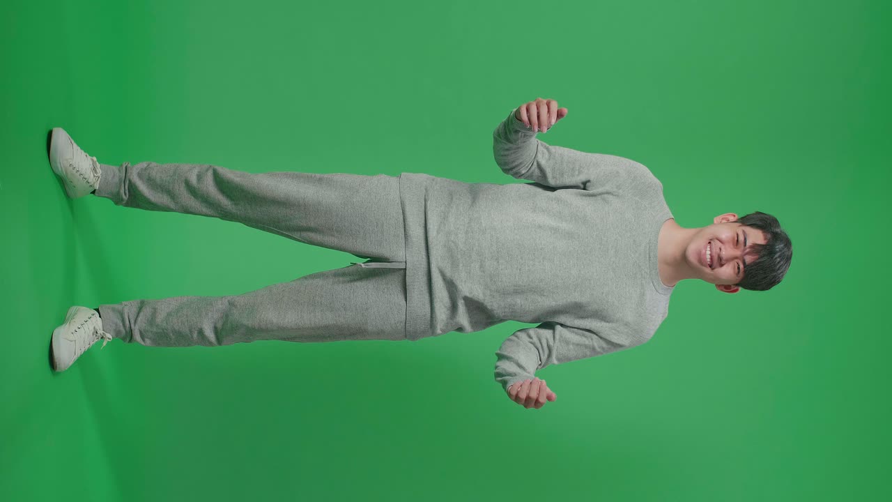Full Body Of Asian Man Showing Gesture Hands Palm Saying Wow And Smiling In The Green Screen Studio
