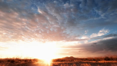 The-sun-rises-in-vibrant-colors-and-shines-over-the-desert-landscape-in-this-time-lapse-cloudscape