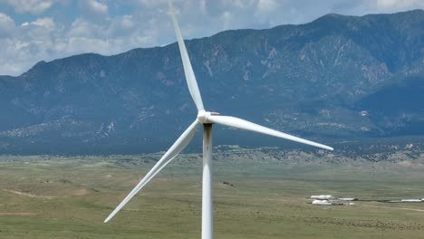 wind turbine spinning in windy mountain region of usa