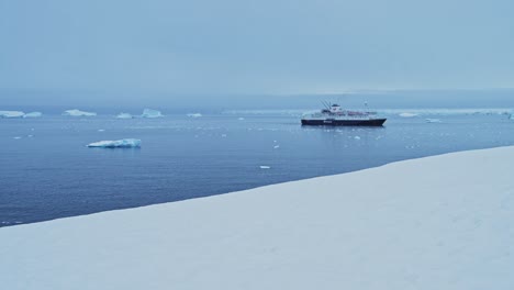 antarctica ship in beautiful scenery, cruise ship boat in dramatic amazing antarctic peninsula scenery and winter landscape on tourist travel vacation and holiday to antarctica