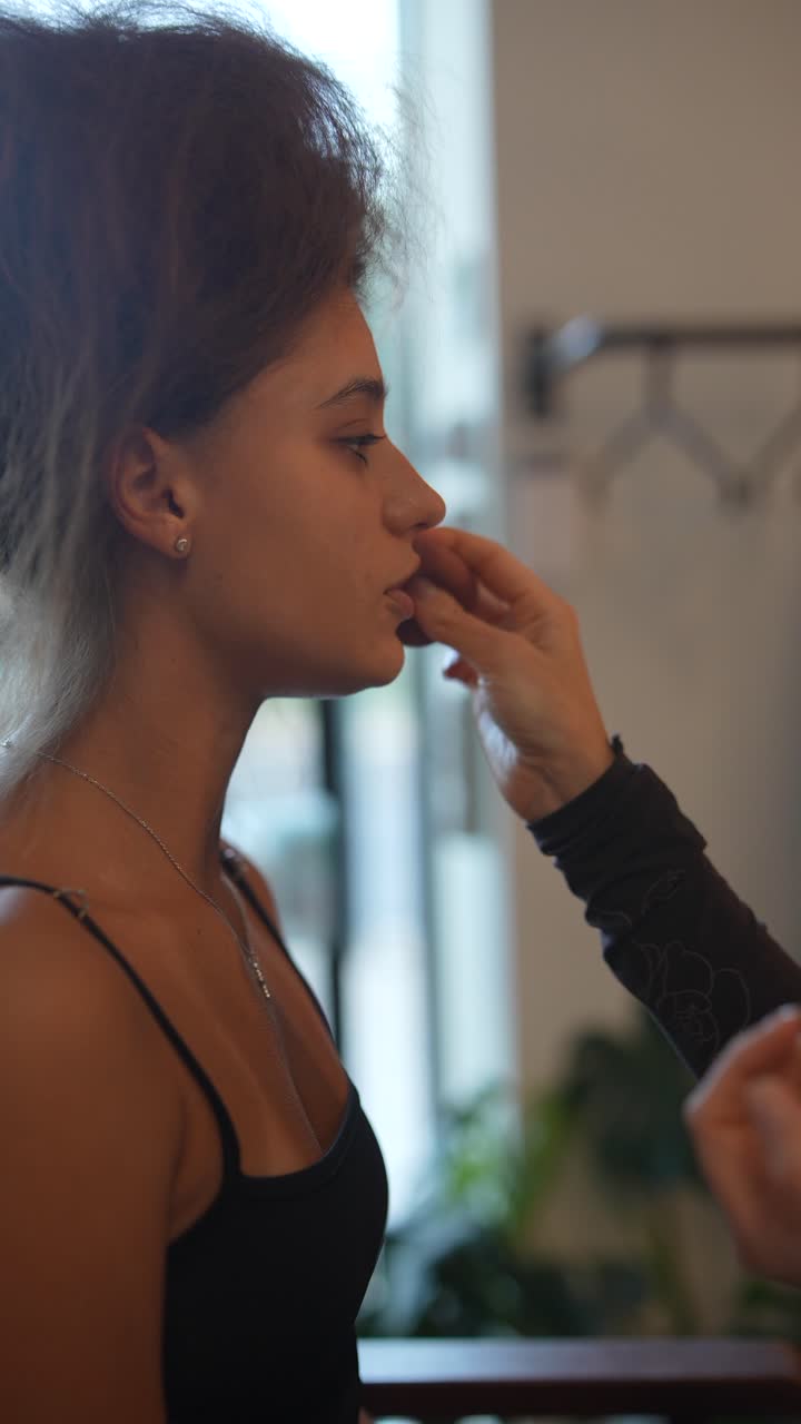 Close-up of a Young Woman Getting Makeup Applied with a Sponge
