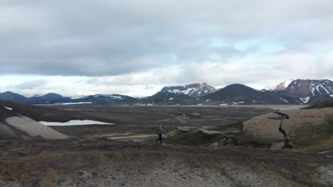Aerial-view-of-sportive-man-runner-training-running-on-mountain-ridge-in-Iceland.-Birds-eye-view-man-running-training-on-mountain-trail-enjoying-skaftafell-national-park-panorama
