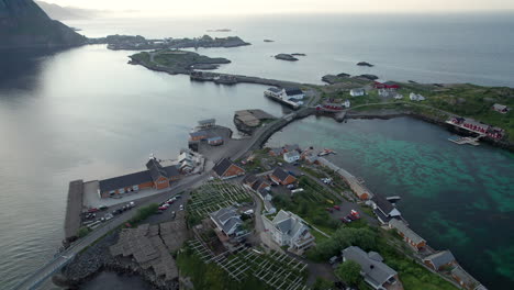 aerial backwards shot of the famous fishing village near reine in lofoten with scenic bridges during midnight sun