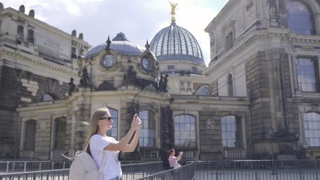 Woman taking photos of a historical building