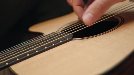 hand practicing and playing the acoustic guitar - close up