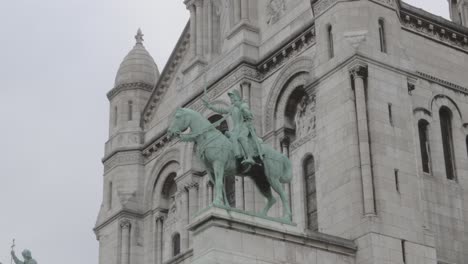 a large building with a statue of a horse and rider on top