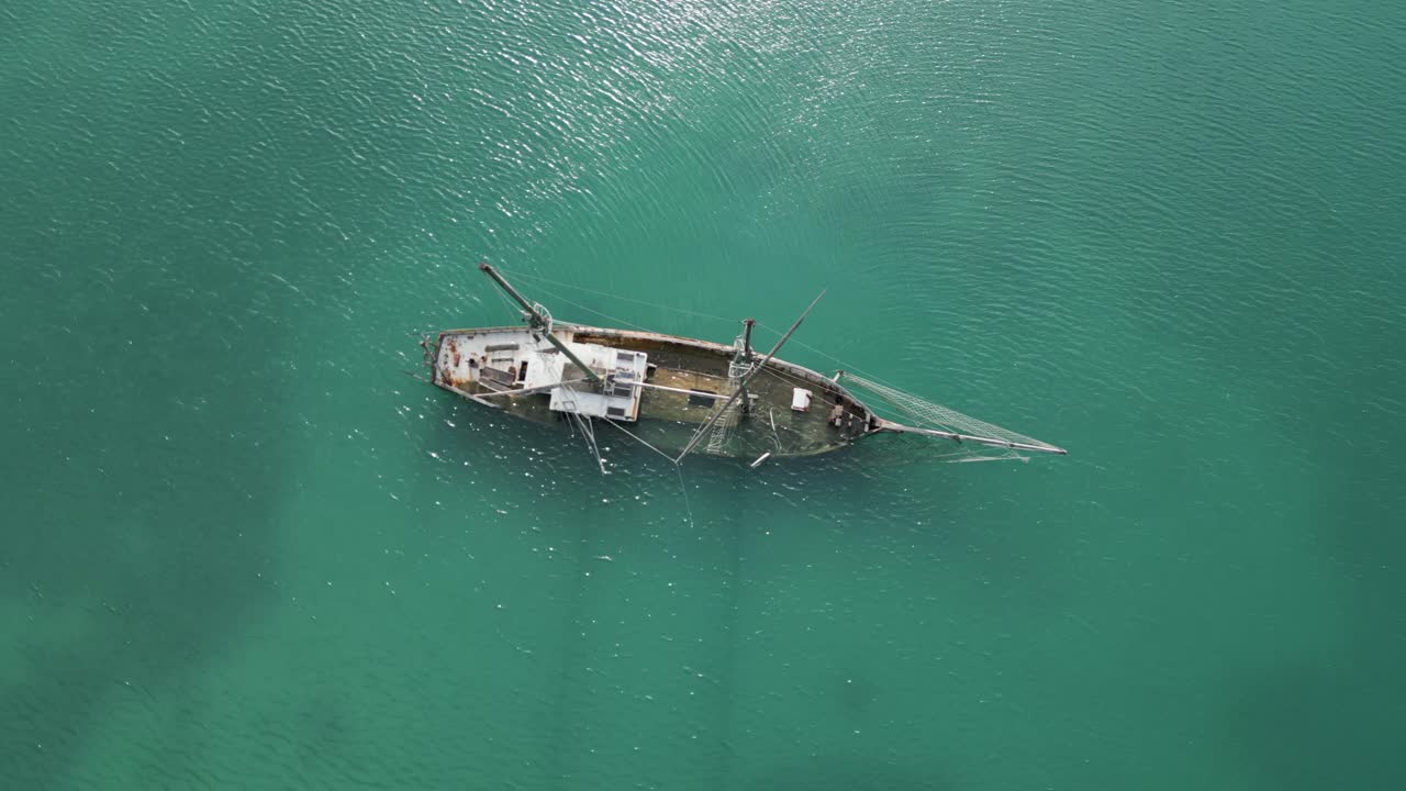 Antique sunken ship in shallow sea, shipwreck in Mediterranean bay aerial view
