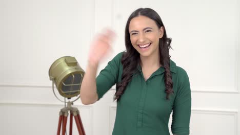 Indian-girl-saying-Hi-and-waving-hand