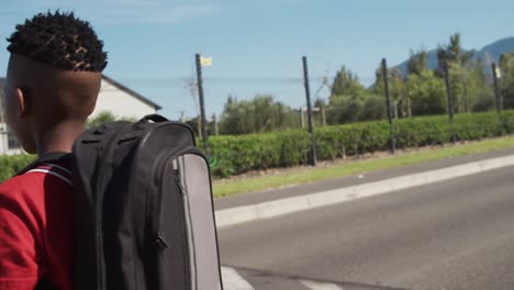 Boy-with-school-bag-crossing-the-road