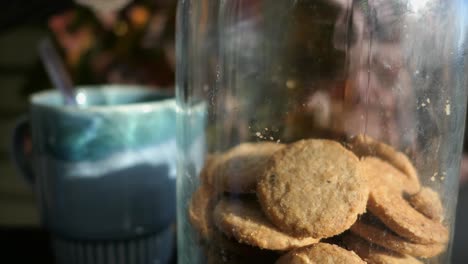 enjoying hot drink and cookies on terrace in autumn, cozy moment close up