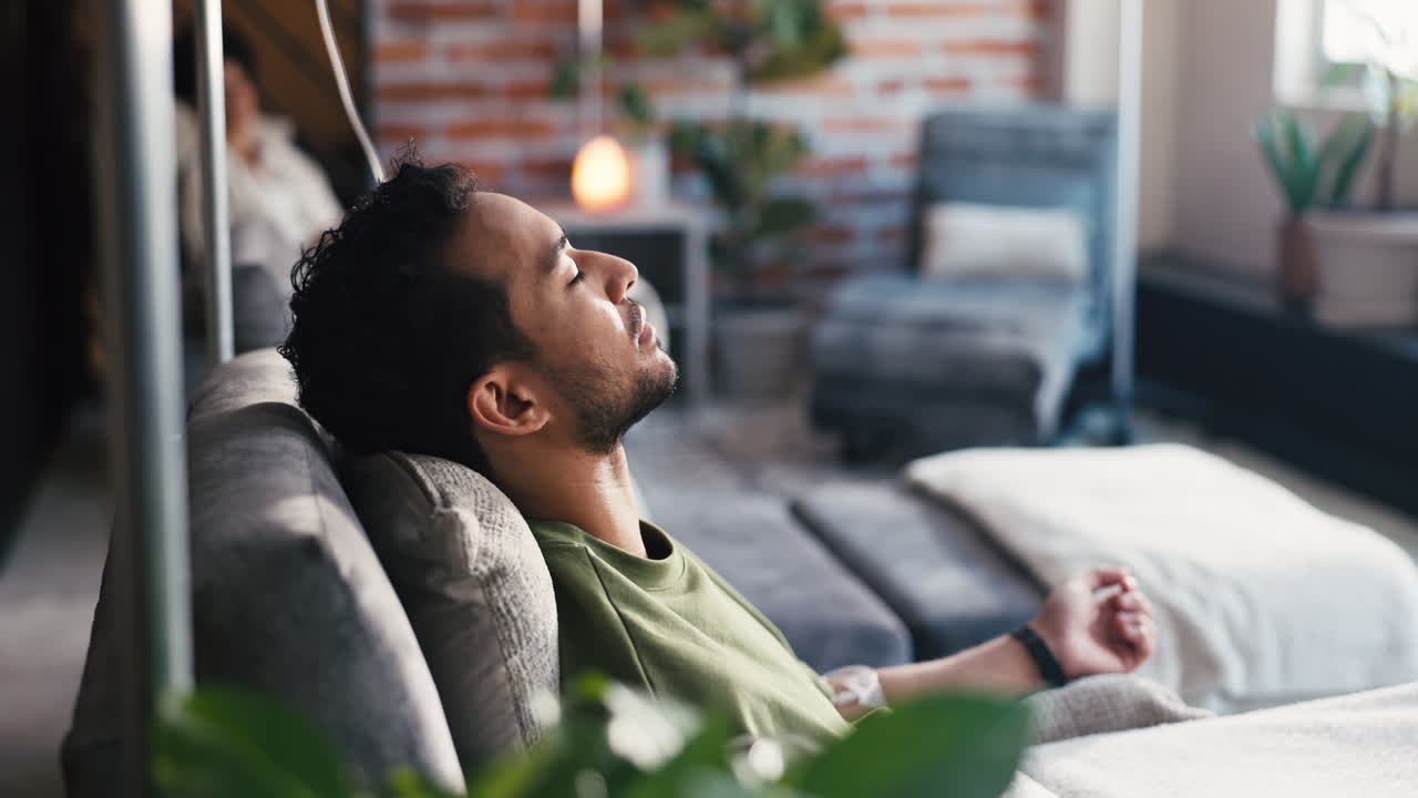 Young Man Relaxing and Resting on a Comfortable Couch at Home