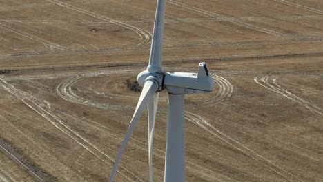 drone orbiting wind turbines, shot on telephoto lens