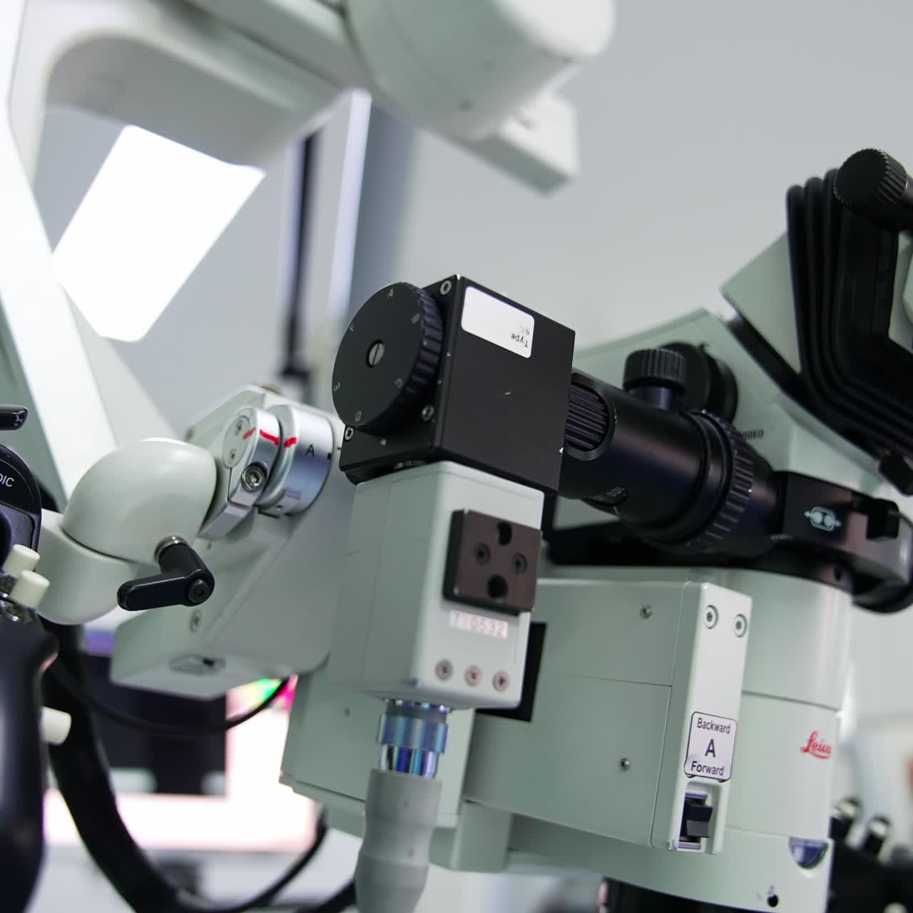 Moving around medical advanced equipment. Closer look at the details of powerful microscope in surgery room