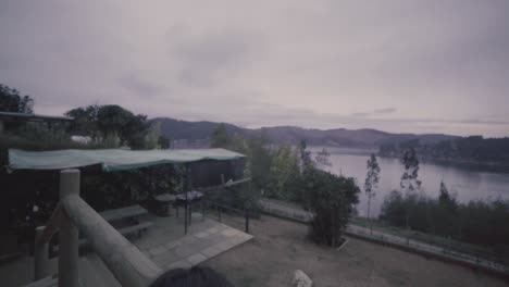 hd of a woman and her dog outdoog house in front of a lake