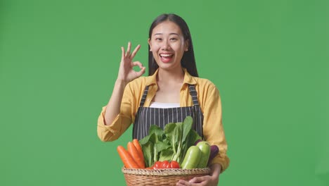 woman holding a basket of fresh vegetables