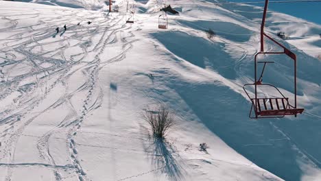 slow motion: camera moving close to the ski lifts in the mountains.